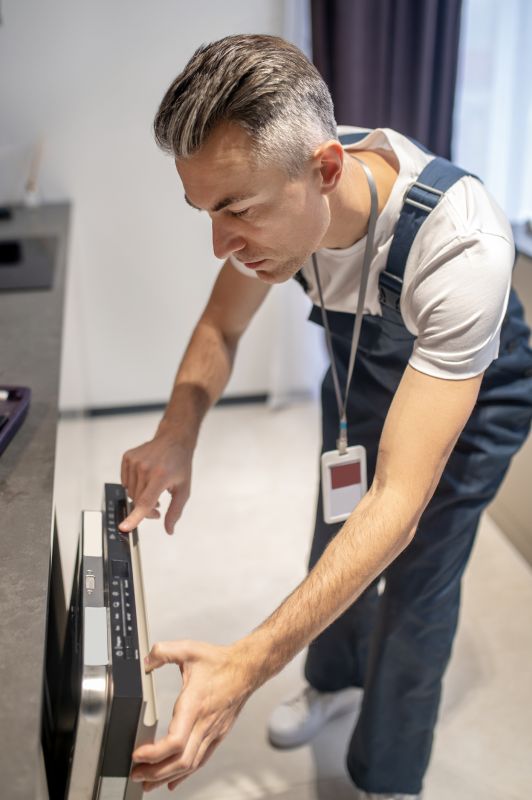 Technician Installing Dishwasher